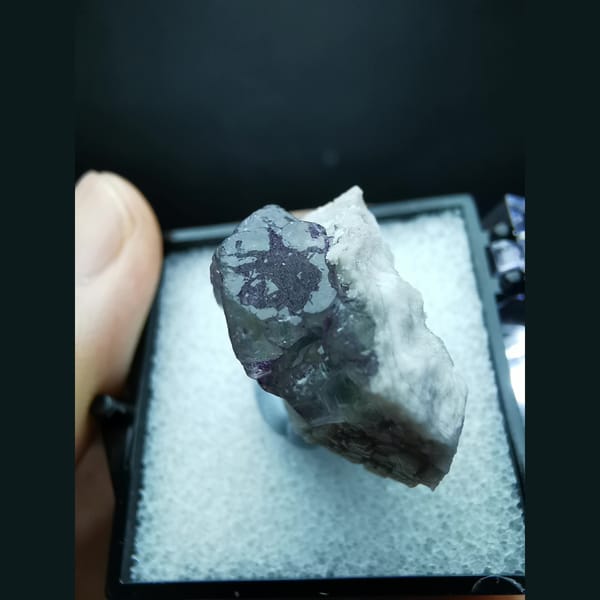 Blue fluorite with purple flower-like etch patterns — detail view