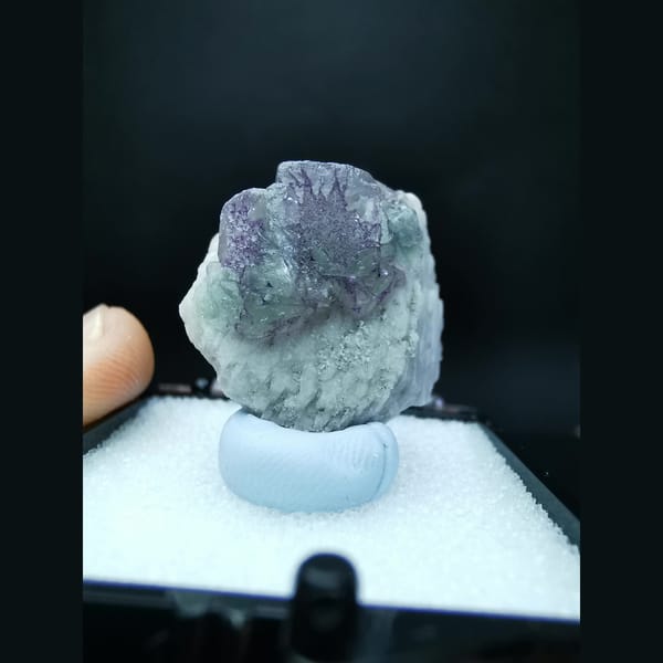 Blue fluorite with purple flower-like etch patterns — detail view