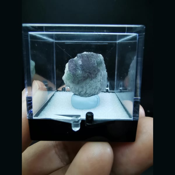 Blue fluorite with purple flower-like etch patterns — detail view