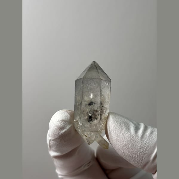 Clear double-terminated quartz with sketch-like markings from Yunnan — complete view