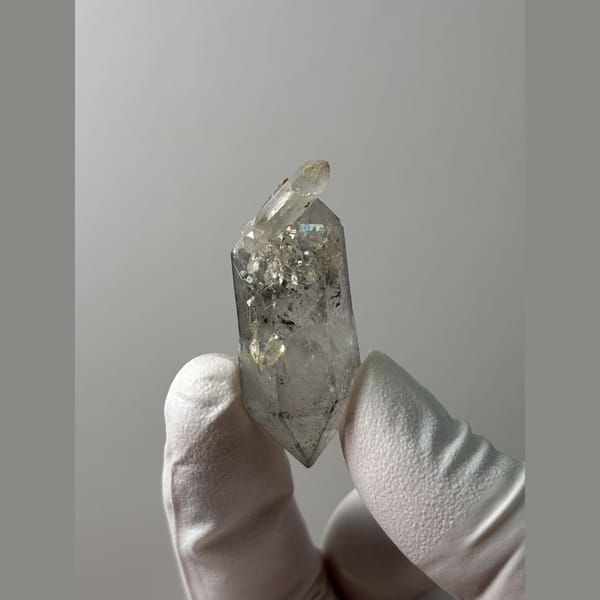 Clear double-terminated quartz with sketch-like markings from Yunnan — detail view