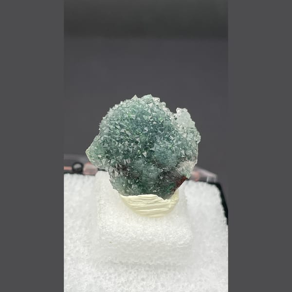 Small quartz cluster with green malachite inclusions from Congo — complete view