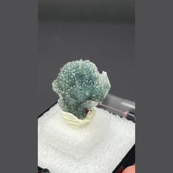 Small quartz cluster with green malachite inclusions from Congo — detail view