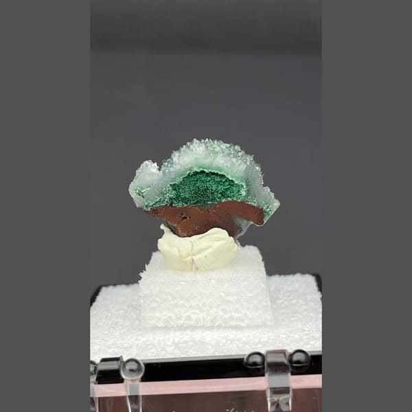 Small quartz cluster with green malachite inclusions from Congo — detail view