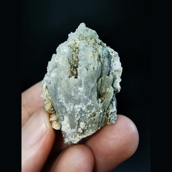 Etched grey-green quartz cluster with calcite — complete view