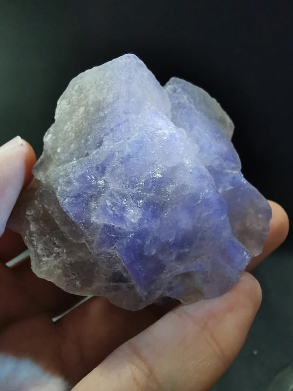 Fluorite on candle quartz — complete view under violet illumination