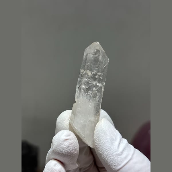 Slender clear quartz crystal from Xuebaoding, Sichuan — detail view