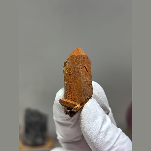 Orange iron-stained quartz crystal from Xuebaoding, Sichuan — complete view