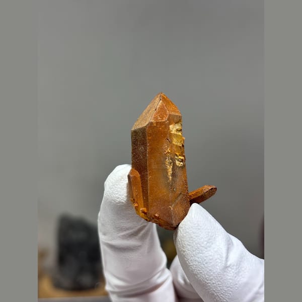Orange iron-stained quartz crystal from Xuebaoding, Sichuan — alternate view