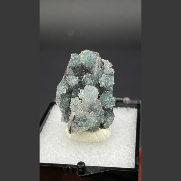 Small quartz cluster with green malachite inclusions from Congo — detail view