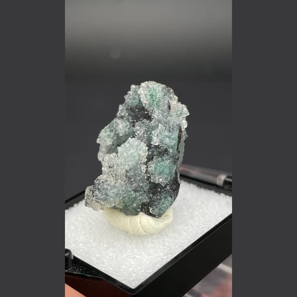 Small quartz cluster with green malachite inclusions from Congo — detail view