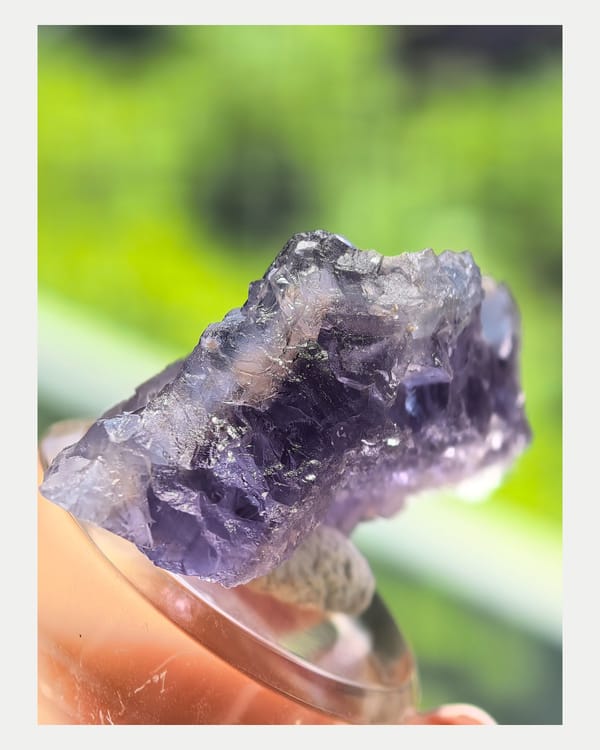 Narrow side view of layered purple fluorite