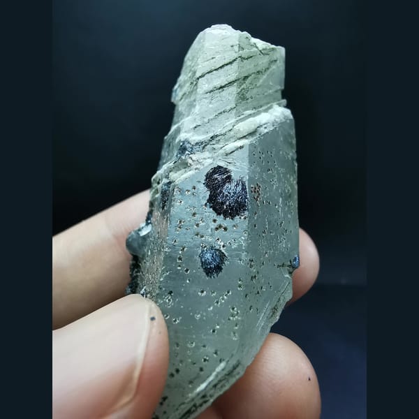 Floater interference quartz with specular hematite flowers — detail view