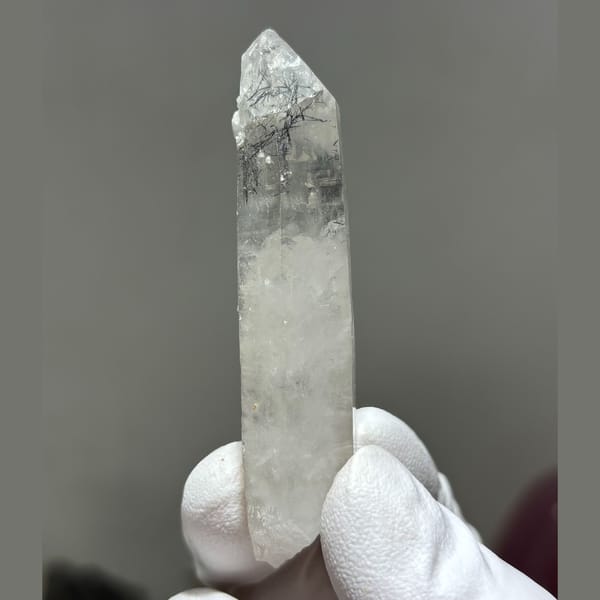Slender tip-chipped Xuebaoding quartz — complete view
