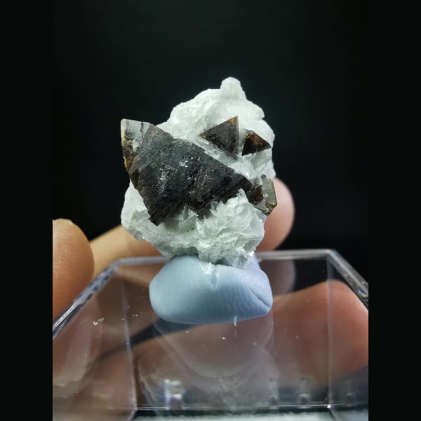 Helvine cluster half-wrapped in calcite — alternate view