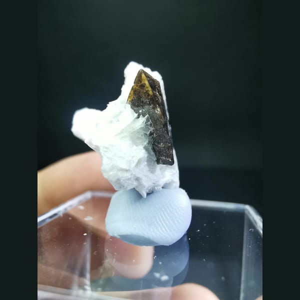 Helvine cluster half-wrapped in calcite — detail view