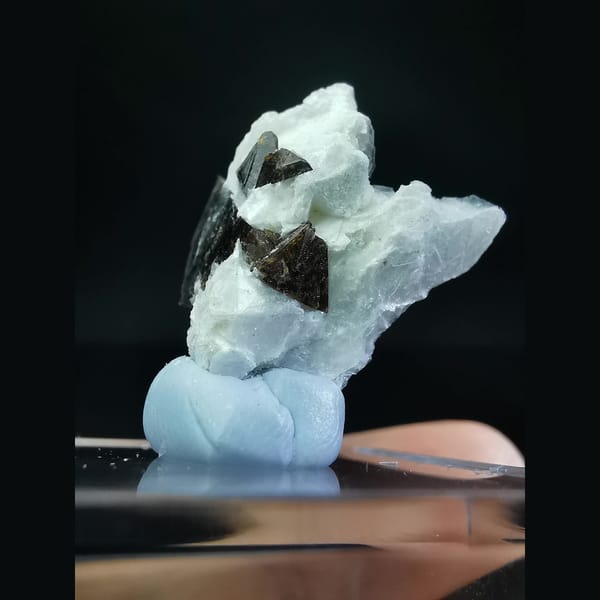 Helvine cluster half-wrapped in calcite — detail view
