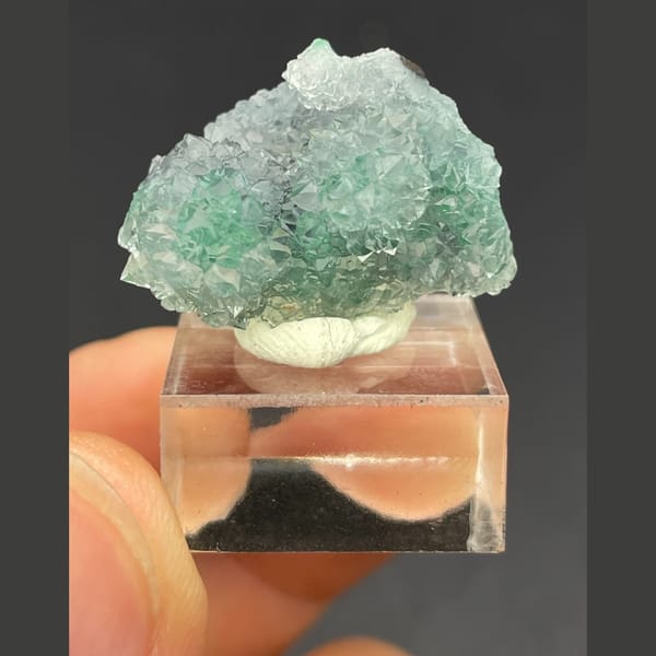 Twin icy quartz balls over malachite from the Congo — complete view