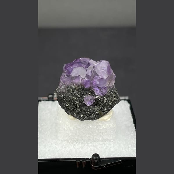 Small violet tanzanite fluorite on dark matrix from Fujian — detail view