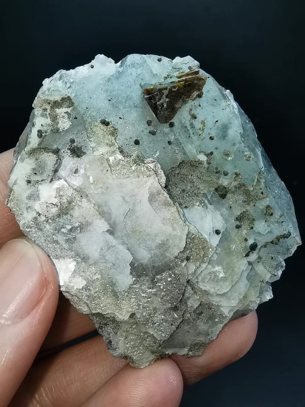 Complete front view of two brown garnets on pale calcite