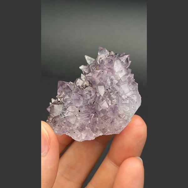 Lilac amethyst crystal group with calcite from Brazil — detail view