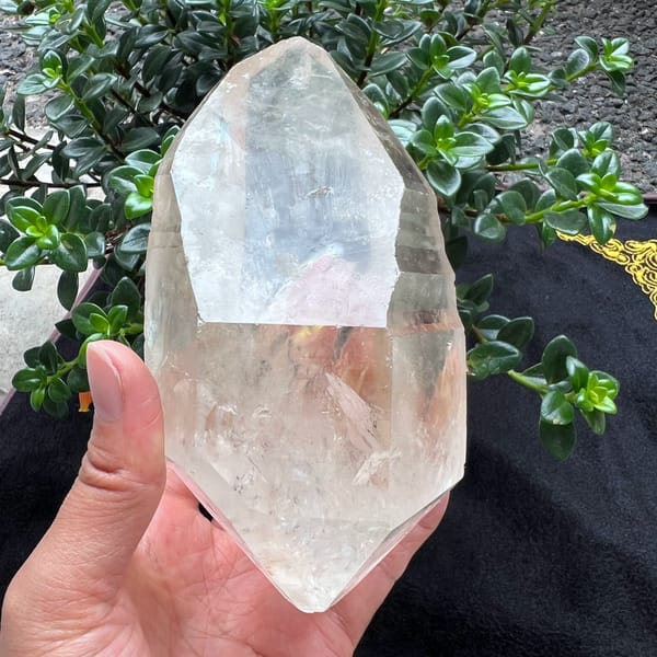 Bright striated clear quartz crystal with rainbows from Brazil — complete view