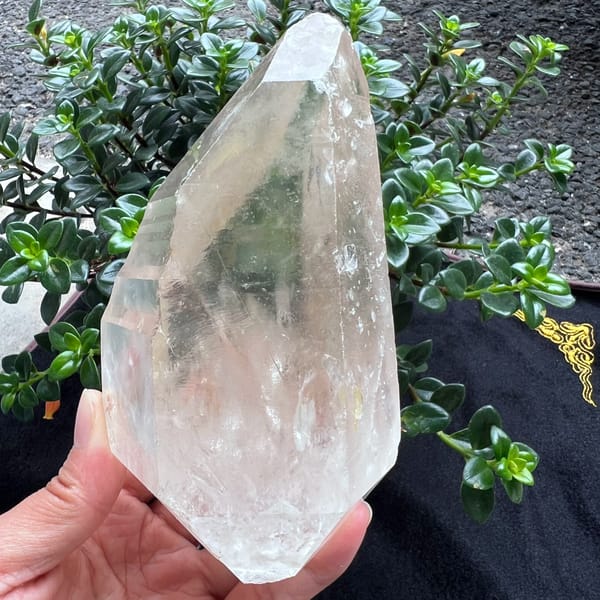 Bright striated clear quartz crystal with rainbows from Brazil — detail view