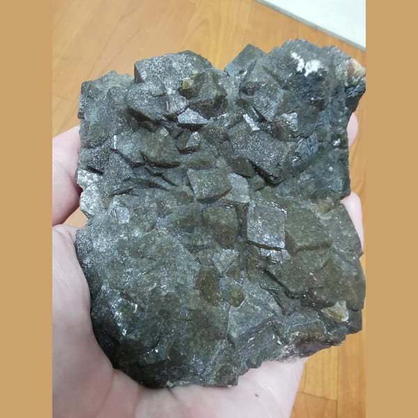 Lustrous brown-green garnet cluster — complete view