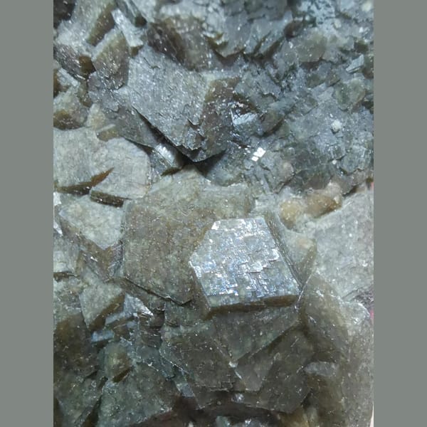 Lustrous brown-green garnet cluster — detail view