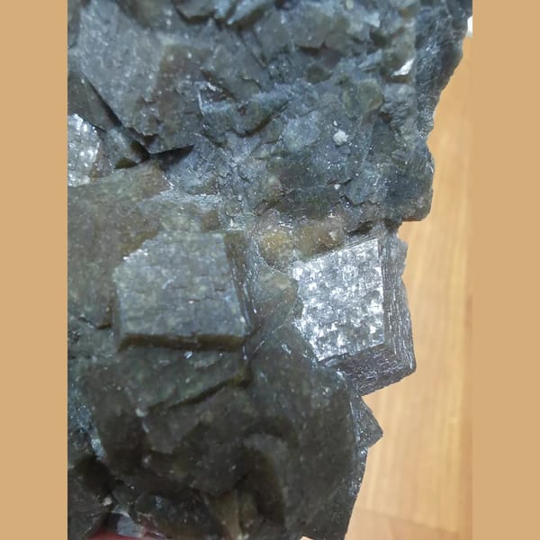 Lustrous brown-green garnet cluster — detail view