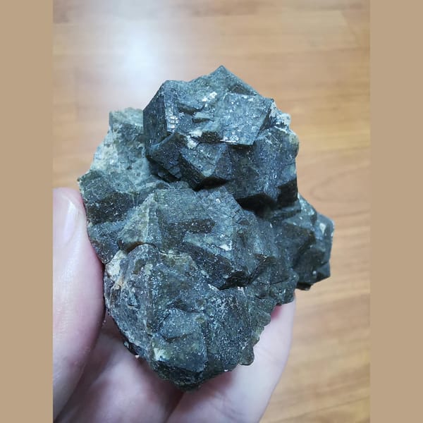 Green andradite cluster with grid-patterned faces — complete view