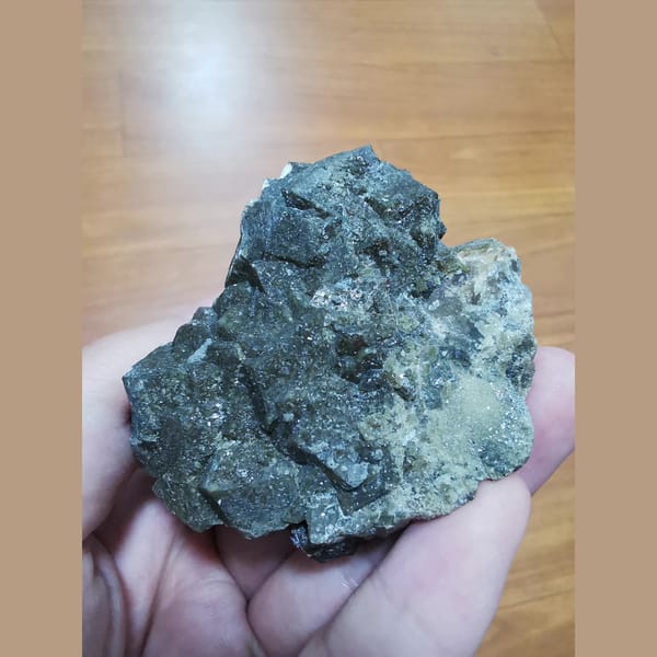 Green andradite cluster with grid-patterned faces — detail view