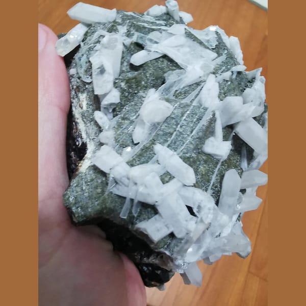 Large green andradite with interference quartz and calcite plates — detail view