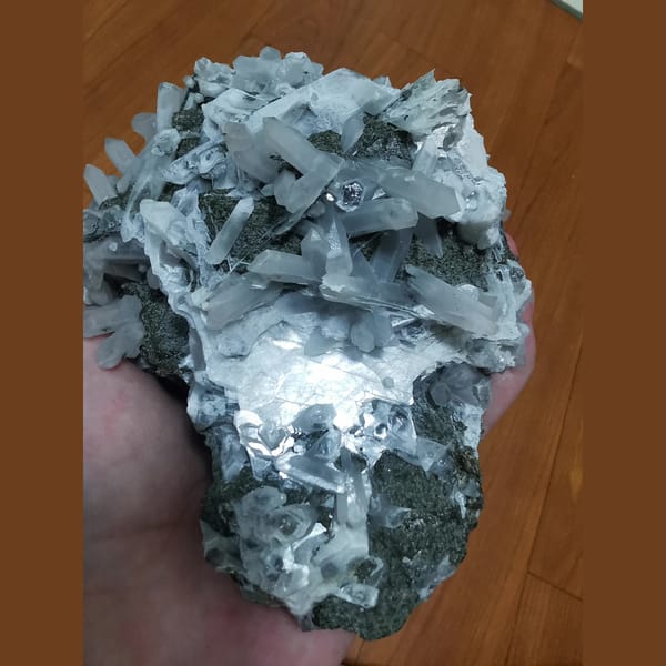 Large green andradite with interference quartz and calcite plates — detail view