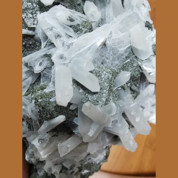 Large green andradite with interference quartz and calcite plates — detail view