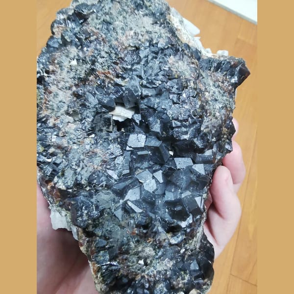 Large green andradite with interference quartz and calcite plates — detail view
