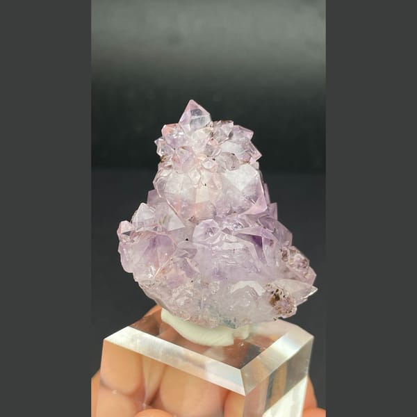 Pale lilac amethyst crystal cluster with calcite from Brazil — detail view