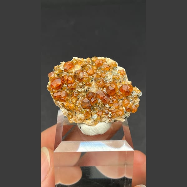 Sparkling orange-red garnet crystal cluster from Fujian — complete view
