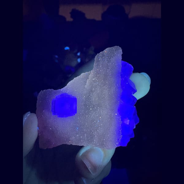Sparkling sugar quartz with a pale green fluorite cube — detail view