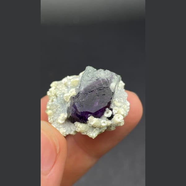 Deep purple-core fluorite crystal nested in mica from Inner Mongolia — complete view