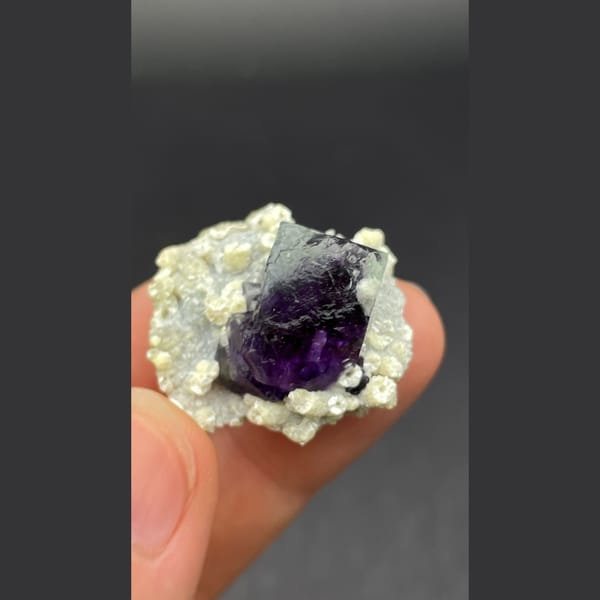 Deep purple-core fluorite crystal nested in mica from Inner Mongolia — alternate view