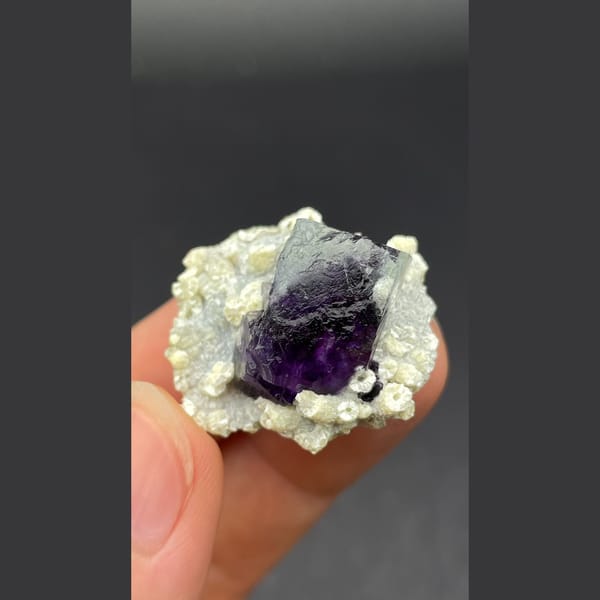 Deep purple-core fluorite crystal nested in mica from Inner Mongolia — alternate view