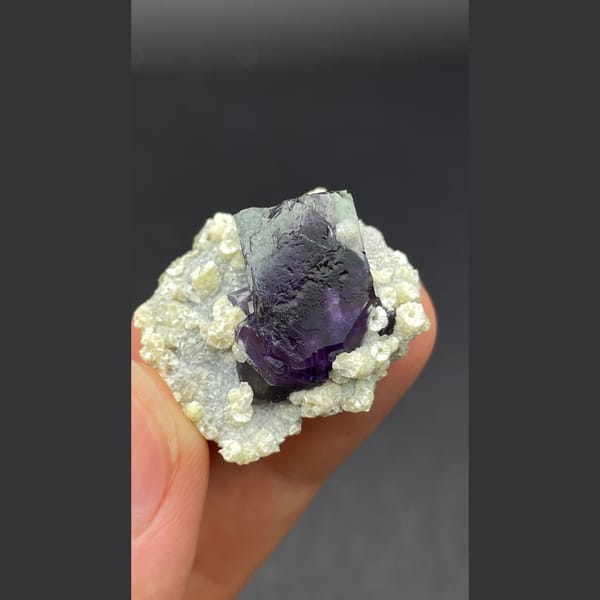 Deep purple-core fluorite crystal nested in mica from Inner Mongolia — detail view