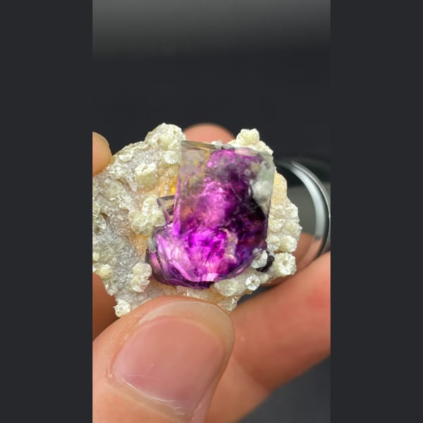Deep purple-core fluorite crystal nested in mica from Inner Mongolia — detail view