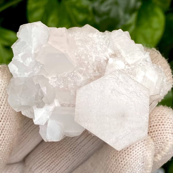 Pale pink hexagonal biscuit calcite with clear quartz — detail view