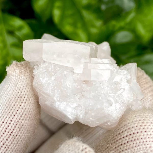 Pale pink hexagonal biscuit calcite with clear quartz — detail view