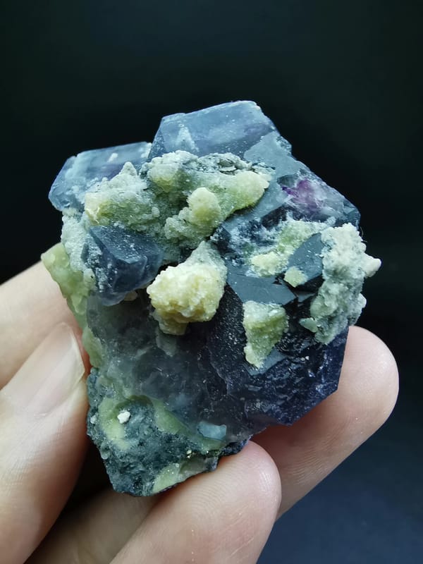 Complete front-oblique view of blue-purple fluorite with pale mica
