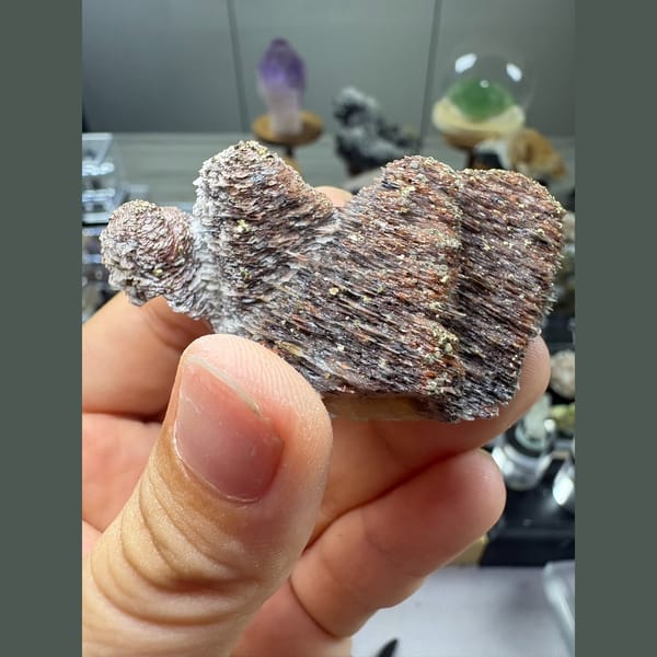 Two stacked towers of bladed calcite with hematite and pyrite — complete view