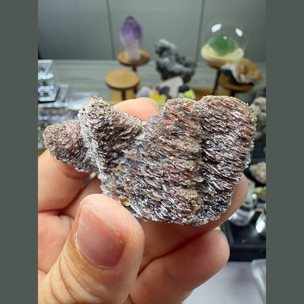 Two stacked towers of bladed calcite with hematite and pyrite — alternate view