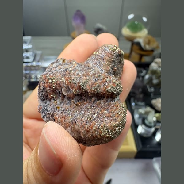 Two stacked towers of bladed calcite with hematite and pyrite — alternate view